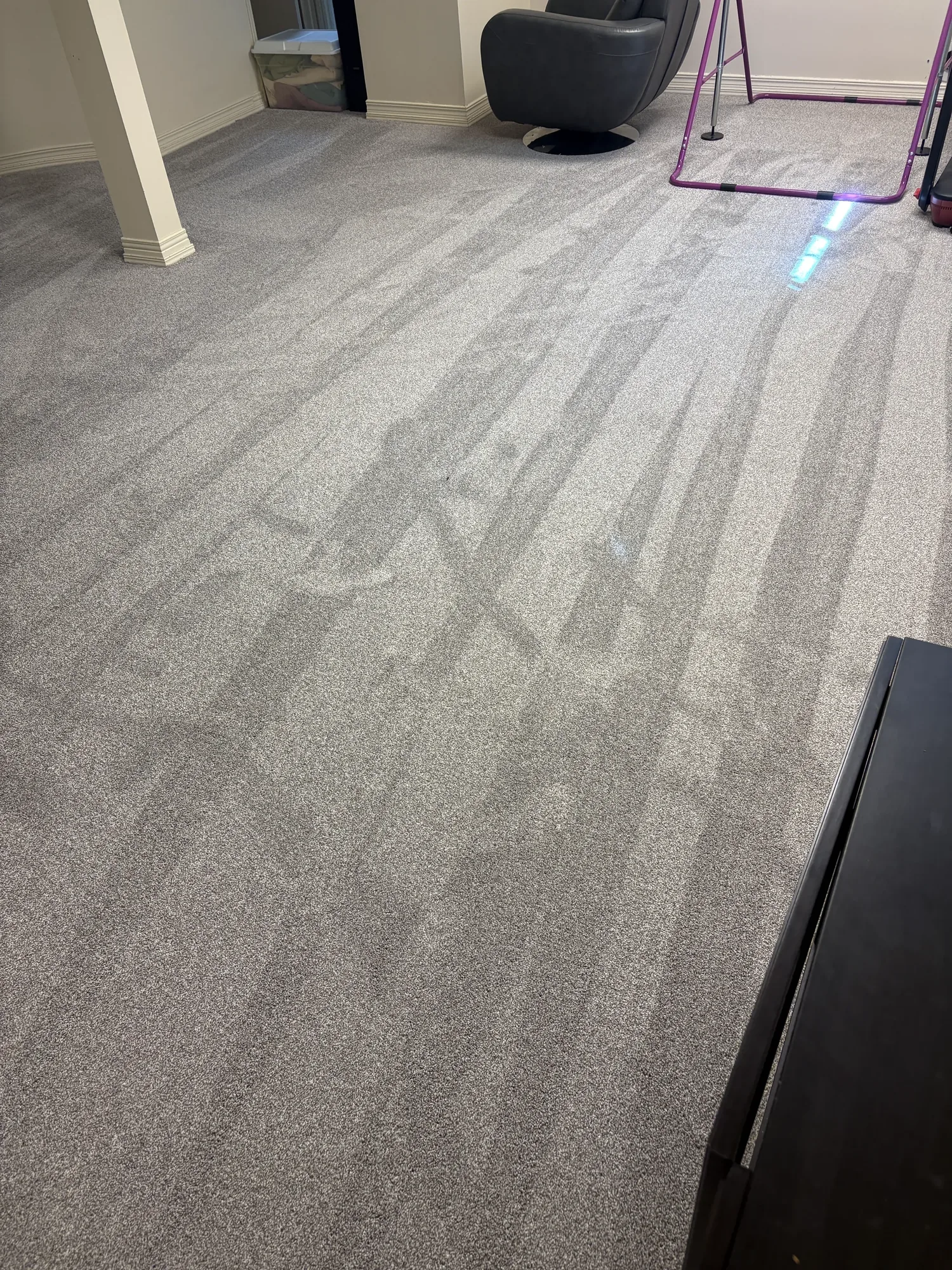 Grey carpet installed wall to wall in a finished basement