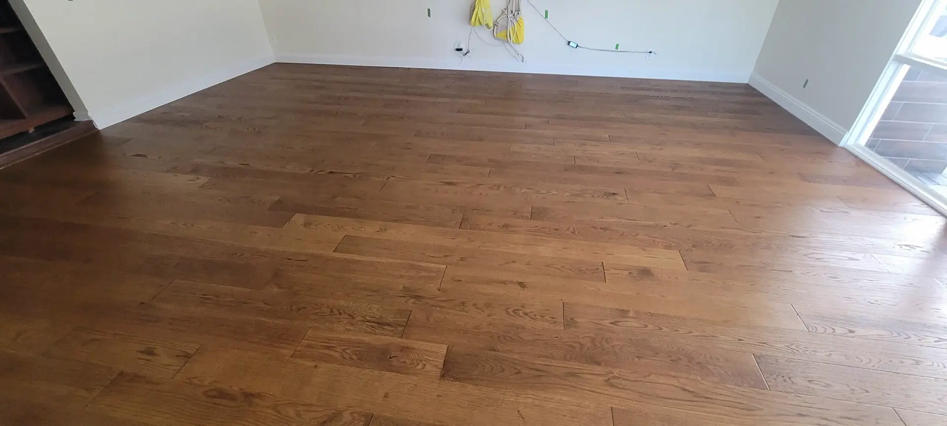 Finished hardwood floor in an empty room